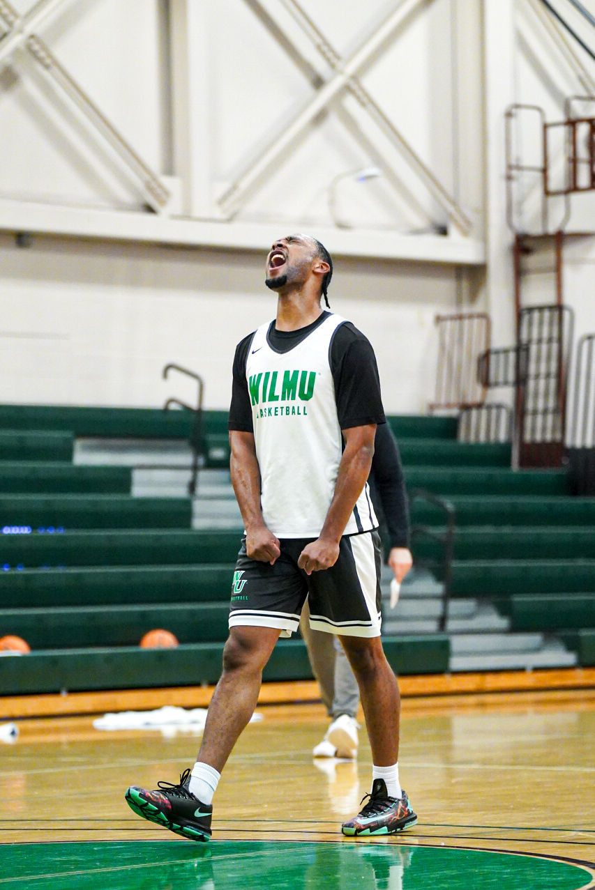 A WilmU player celebrating in the gym